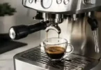 Espresso from a Barista Express with visible coffee grounds in the cup